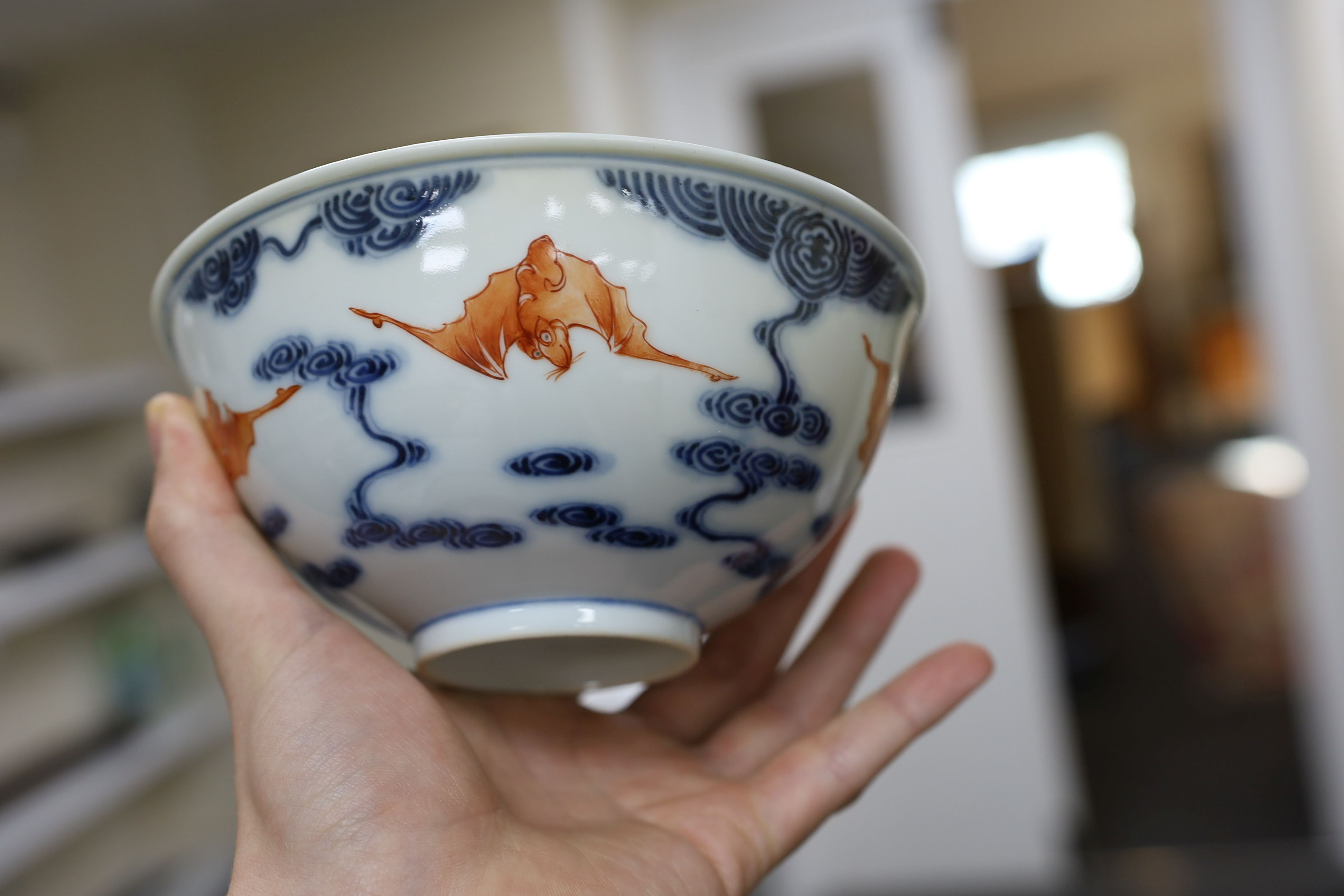 A pair of Chinese iron red and underglaze blue ‘five bat’ bowls, Guangxu mark and probably of the period (1875-1908), 16.5cm diameter